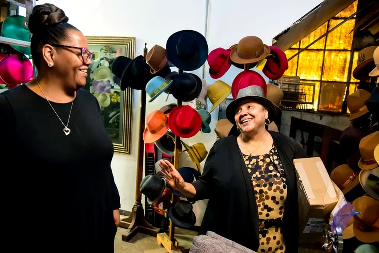 The Rev. Georgiette Morgan-Thomas (right) meets with hat designer Stephanie Marbury of Crown Princess Hats at Morgan-Thomas' hat factory. She wasn't ready to see the former S&S Hat Co. in Wissinoming shut down in 2015, so, with her life's savings, she bought it.
