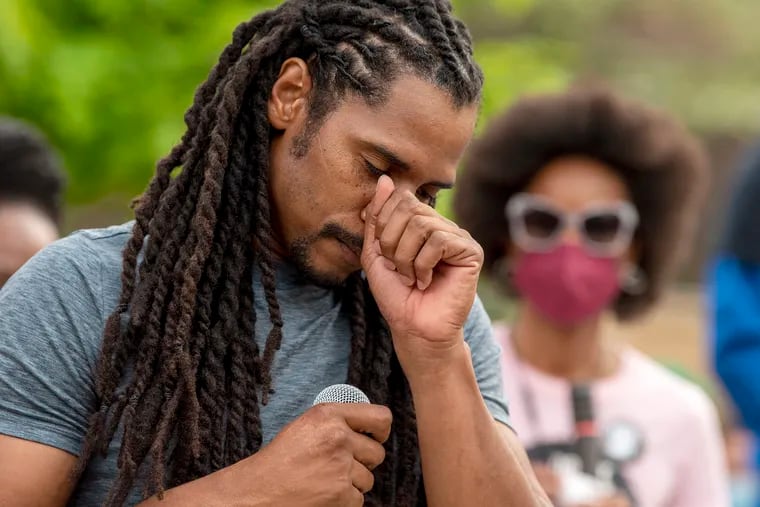 Mike Africa, Jr. pauses as he becomes emotional while addressing a protest in front of the Penn Museum over its handling of human remains from the MOVE bombing.
