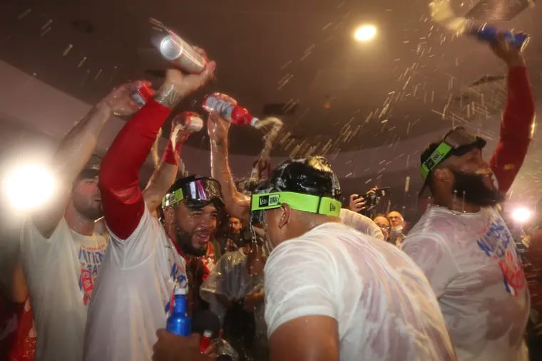 Phillies third baseman Edmundo Sosa and pitcher Ranger Suarez celebrate after the Phillies beat the San Diego Padres in Game 5 to clinch the National League Championship — and a World Series berth.
