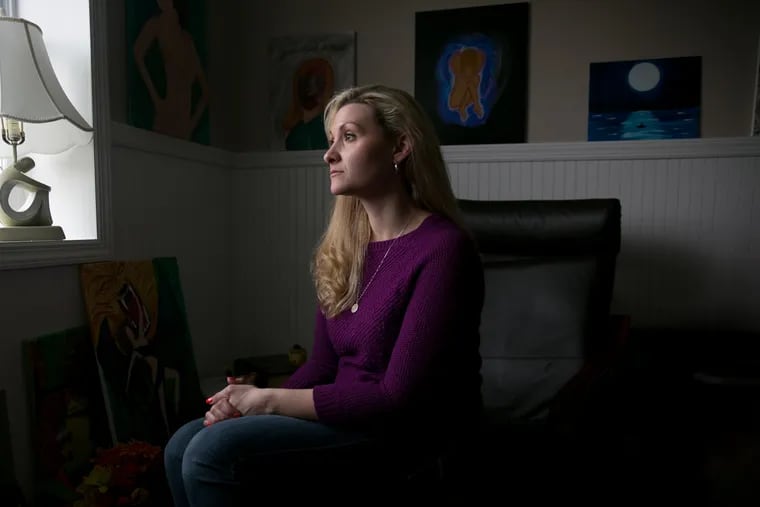 Sarah Brooks was raised a Jehovah's Witness, she was sexually abused for two years when she was a teenager by a male family friend and a former sister-in-law, she is shown here in a room in her home that she uses as a painting studio, she is surrounded by some of her paintings, in Felton, Pennsylvania, Wednesday, April 25, 2018. Sarah continues art therapy as a means of coping with her past abuse. JESSICA GRIFFIN / Staff Photographer