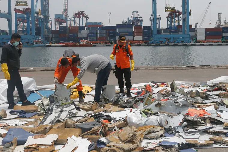 Investigators examine parts of Lion Air Flight 610 retrieved from the waters off Tanjung Priok in Jakarta, Indonesia, on Wednesday.