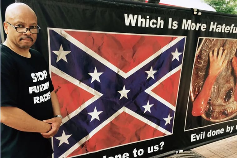 The Rev. Clenard Childress with a Confederate flag poster, taunting the NAACP on its abortion-rights position. (STU BYKOFSKY/DAILY NEWS STAFF)