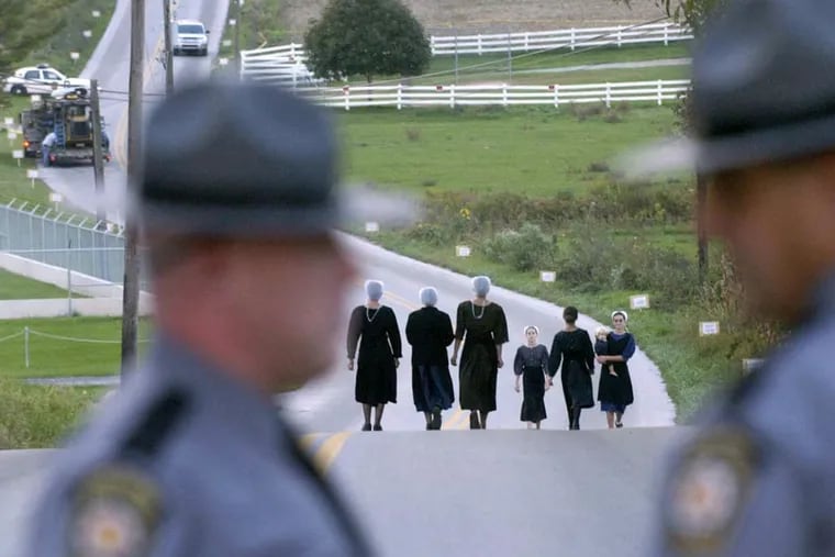 Amish women leave the Nickel Mines schoolyard on Oct. 3, 2006, as the murder investigation continued.