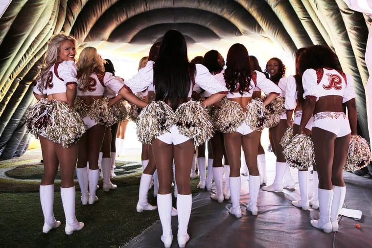 Washington Redskins cheerleaders wait to go onto the field prior to a game against the Eagles on Sept. 10, 2017, in Landover, Md.