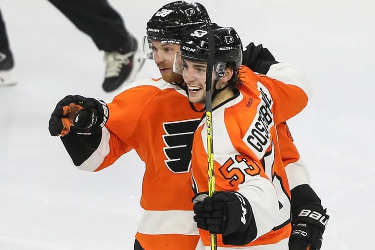 The Flyers' Claude Giroux celebrates his goal with teammate Shayne Gostisbehere during the third period Tuesday against the Islanders.
