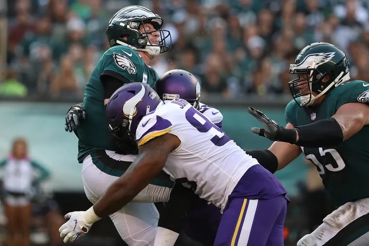 Carson Wentz, shown here getting drilled by Minnesota defensive tackle Tom Johnson, threw for 311 yards in last season's loss to Minnesota. The Eagles offense did not score a touchdown in the first three quarters of that game.