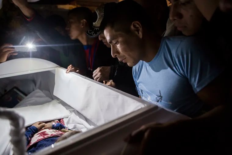 Family members pay their final respects to 7-year-old Jakelin Caal Maquin during a Christmas Eve memorial service in her grandparent's home in San Antonio Secortez, Guatemala.
