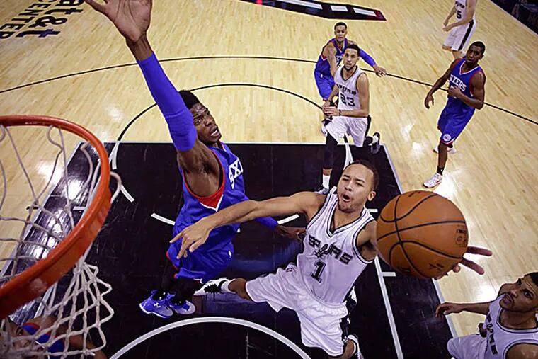 The Spurs' Kyle Anderson shoots around 76ers defender Nerlens Noel during the second half. (Eric Gay/AP)