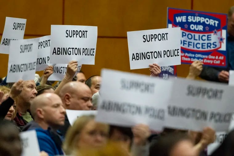 Community members hold signs in support of the Abington police on Tuesday. New Abington School Board member Tamar Klaiman sparked a social media firestorm by commenting recently that black and brown students were more likely to be shot by police, particularly school resource officers. Police supporters have expressed outrage.