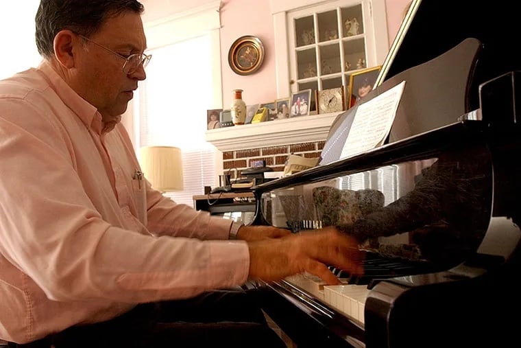 Casino piano tuner Charlie Birnbaum’s deft touch is reflected in the grand piano as he plays in the Atlantic City home that had belonged to his parents.