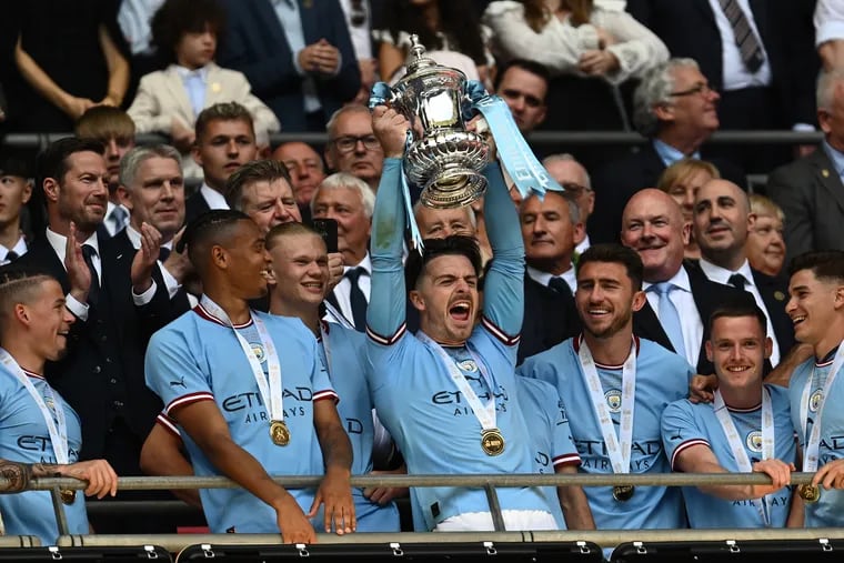 Jack Grealish of Manchester City lifts the trophy at the end of the Emirates FA Cup Final between Manchester City and Manchester United at Wembley Stadium on June 03, 2023 in London, England. (Photo by Mike Hewitt/Getty Images)
