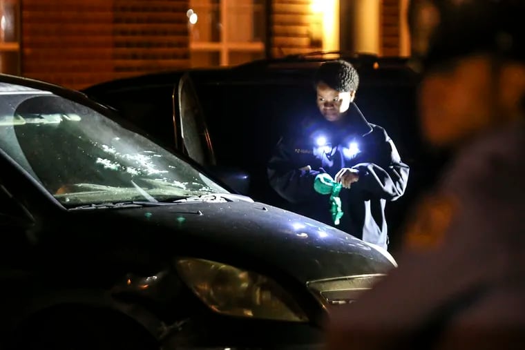 Police on 900 block of South 4th Street examine windshield of minivan in which the driver, a 42-year-old man, was shot 10 times while his two teen daughters, who also were in the vehicle, survived unharmed. Monday, November 1, 2021.