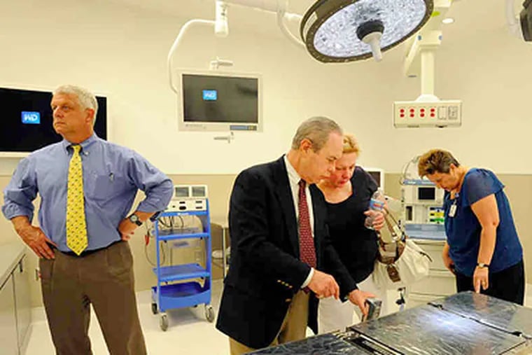 The mock operating room gets a look from (from left) Rick Fine, anesthesiology chairman; Bruce Menkowitz, an orthopedist who is chief of surgery; Patricia Clark, clinical manager for surgical services; and Ginger Kelly, clinical support specialist. (Sharon Gekoski-Kimmel / Staff Photographer)