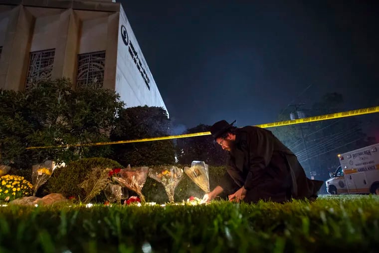 Rabbi Eli Wilansky lights a candle after a mass shooting at Tree of Life Congregation on Saturday, Oct. 27, 2018, in the Squirrel Hill neighborhood of Pittsburgh.