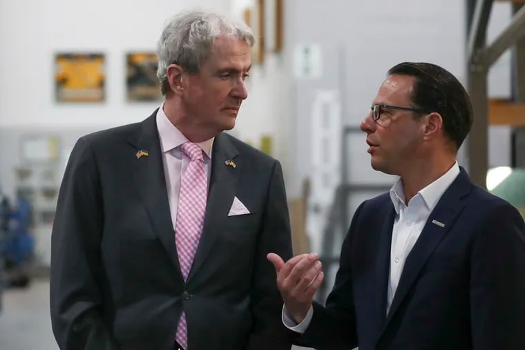 Gov. Phil Murphy (left) speaks with Gov. Josh Shapiro as they tour the Finishing Trades Institute in Philadelphia on Thursday. The governors held a press conference after the tour to announce a partnership to form an interstate task force to address wage theft and worker misclassification in both their states.