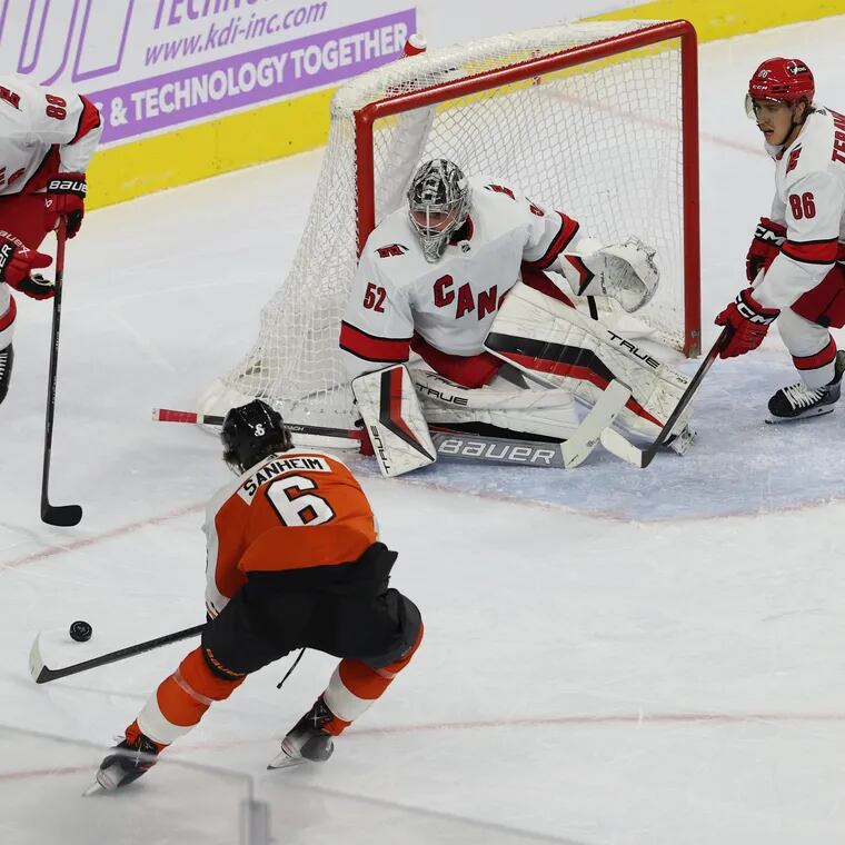 Despite a great move to get an opportunity, Travis Sanheim (center) of the Flyers fails to score against Carolina goalie Pyotr Kochetkov during the first period of their game at the Wells Fargo Center on Tuesday.
