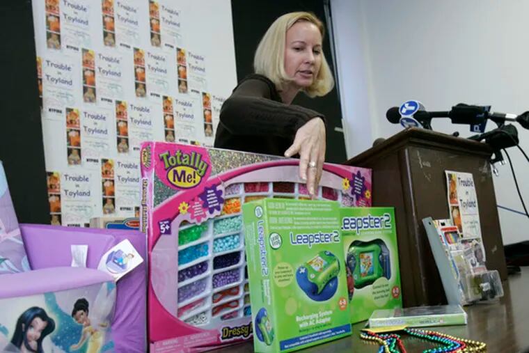 Tracy Shelton, of the New York Public Interest Research Group, points to a toy called Leapster 2, which contained toxic levels of arsenic. She spoke at a news conference yesterday to raise awareness about toys that are dangerous for children. Toy-related injuries in 2007, Consumer Product Safety Commission data show, affected 80,000 children under the age of 5.