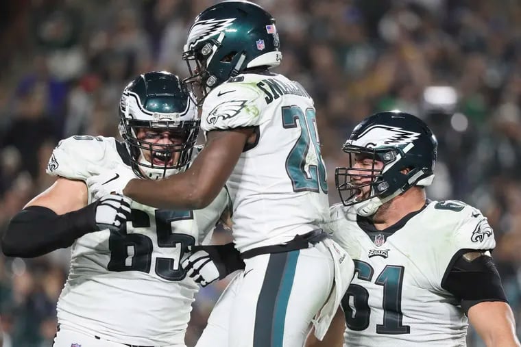 Eagles running back Wendell Smallwood celebrates his third-quarter touchdown run with offensive tackle Lane Johnson and offensive guard Stefen Wisniewski (right) against the Los Angeles Rams on Sunday, December 16, 2018 in Los Angeles.  DAVID MAIALETTI / Staff Photographer
