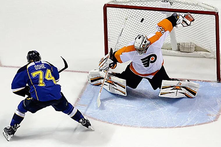 The Blues' T.J. Oshie scores past Flyers goalie Ray Emery. (Jeff Roberson/AP)