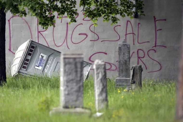 Graffiti marks a wall at the Evergreen Cemetery in Camden, N.J.