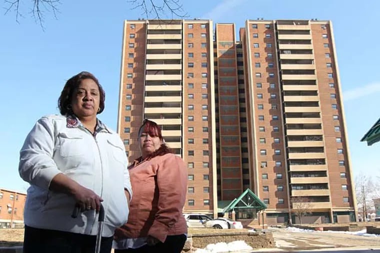 Phara Regusters, left, Tenant Council President, and Alicia Perez, right, Tenant Council Secretary, stand before one of the two Blumberg towers that will be torn down in an effort to redevelop the neighborhood. Most tenants, who will be relocated and guaranteed first dibs on any new replacement units, welcomed the news. The demolition of the towers will be the next step in a far-reaching plan to redevelop the neighborhood. 03/05/2014 ( MICHAEL BRYANT / Staff Photographer )