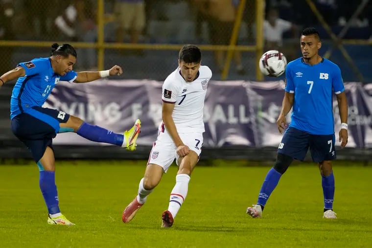 El Salvador's Alex Larín, left, and the United States' Gio Reyna, center, fight for the ball during Thursday's game as Darwin Cerén, right, looks on.