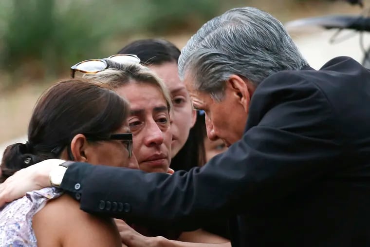 The Archbishop of San Antonio, Gustavo Garcia Seller, comforts families outside of the Civic Center following a deadly school shooting at Robb Elementary School in Uvalde, Texas, Tuesday, May 24, 2022.