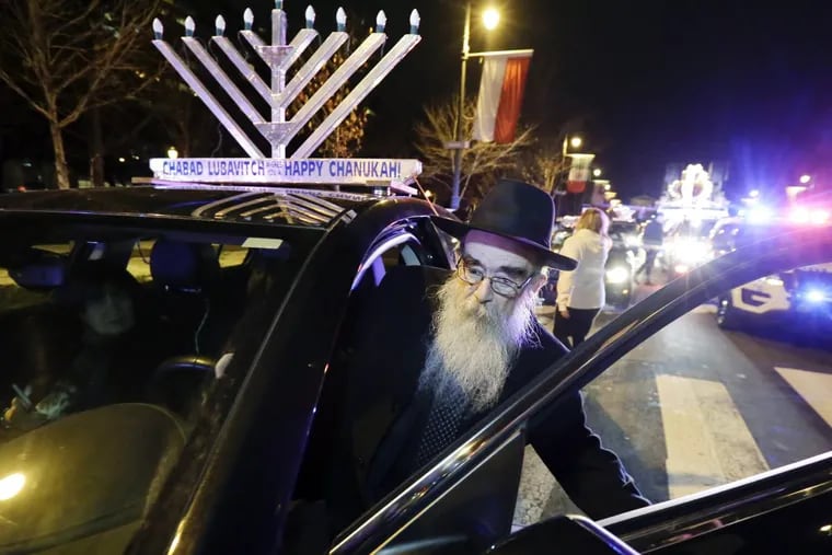 Rabbi Abraham Shemtov leads a parade of menorah-topped cars from Benjamin Franklin Parkway to Independence National Park. The event was held to celebrate the fifth night of Hanukkah.