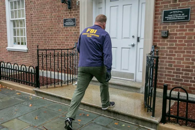 An FBI agent enters the Spring Garden Street headquarters of Local 98 of the International Brotherhood of Electrical Workers on Friday in Philadelphia
