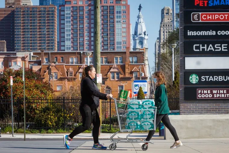 Mandy McHale of Philadelphia picking up bottled water for herself and friend, Customers at Sprouts grocery at S. Broad and Carpenter in Philadelphia buying water after a shipment arrived on Monday, March 27, 2023.