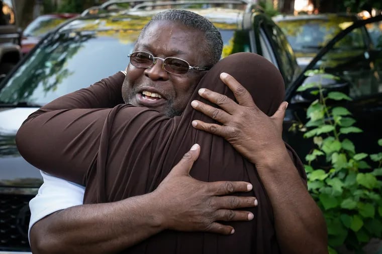 Curtis Crosland, left, receives a hug from his sister Shirley Crosland after being released from prison for a crime he did not commit, in the Cobbs Creek neighborhood of Philadelphia, June 24, 2021.