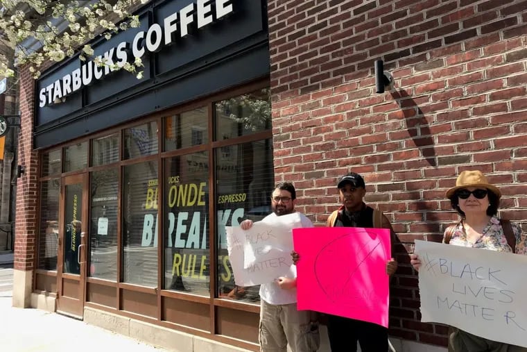 Protesters demonstrate outside the Starbucks at 18th and Spruce Streets.