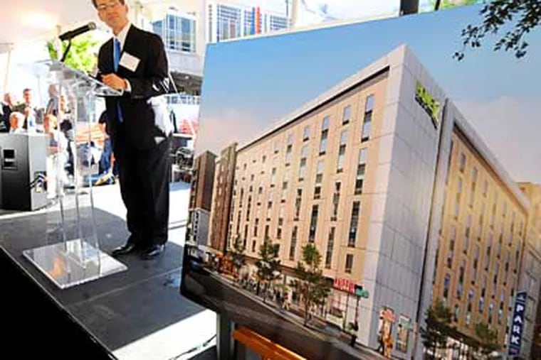 In front of an architect's rendering at groundbreaking ceremonies, Robert Zuritsky, president of Parkway Corp. discusses the new Hilton Home2Suites Hotel his company is building at the corner of 12th and Arch Sts., across from the Pennsylvania Convention Center Tuesday, April 17, 2012.  ( Clem Murray / Staff Photographer )