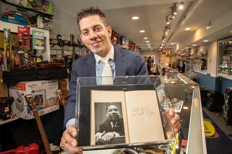 Peter M. Del Borrello III, co-owner of 1st United Pawn & Loan, holds the Bible that he says bears an authenticated signature by the Rev. Dr. Martin Luther King Jr.