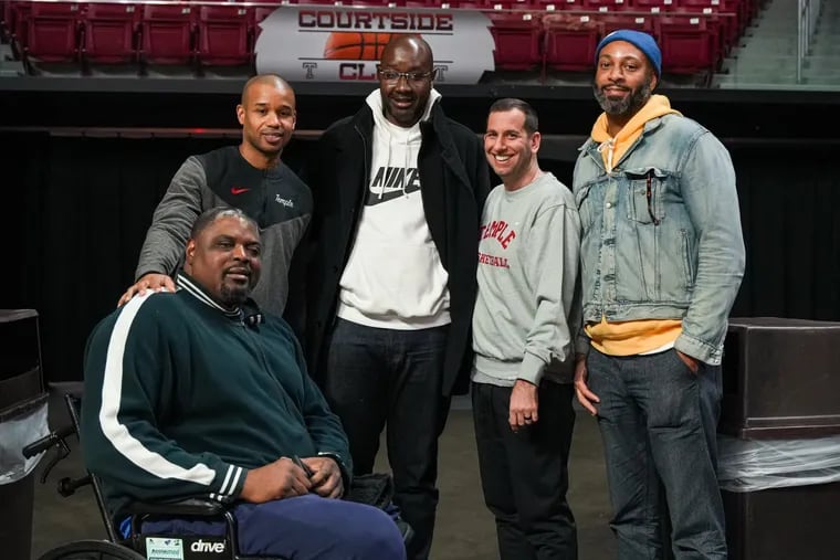 Members of Temple's 1999 Elite Eight team pose with current head coach Adam Fisher, fourth from left, ahead of Temple's game against Charlotte on Feb. 9, 2024.