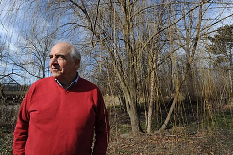 At Awbury Arboretum, new executive director Christopher R. van de Velde near a winter-bare weeping willow.