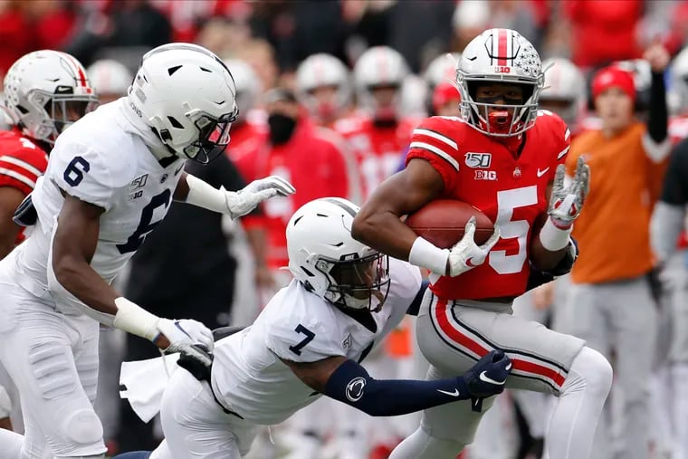 Penn State's Cam Brown (6) and Jaquan Brisker chase down Ohio State receiver Garrett Wilson.