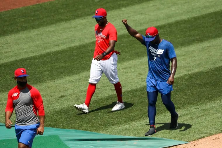 Jean Segura and Roman Quinn walk as Andrew McCutchen raises his fist during back during the Phillies' summer camp back on July 9. The Phillies and Nationals did not take the field Thursday in protest of racial injustice following the shooting of Jacob Blake by Wisconsin police.