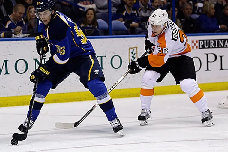 The Blues' Magnus Paajarvi handles the puck as the Flyers' Erik Gustafsson gives chase. (Jeff Roberson/AP)