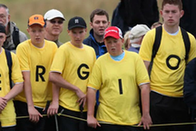 Fans show off T-shirts spelling out the name of first-round leader Sergio Garcia (below).