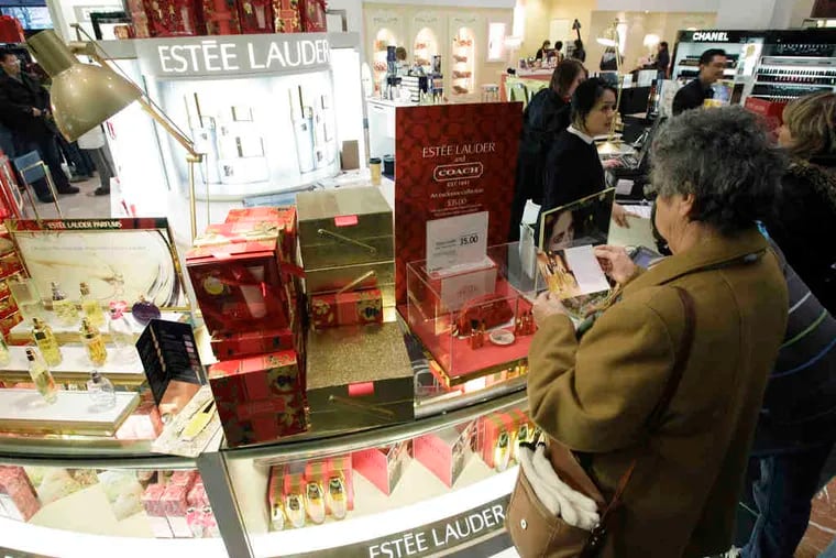 A shopper surveys the Estee Lauder counter in a Macy's store in downtown Seattle. Several companies that sell affordable luxury-type products are reporting stronger-than-expected earnings that suggest that shoppers are making modest splurges.