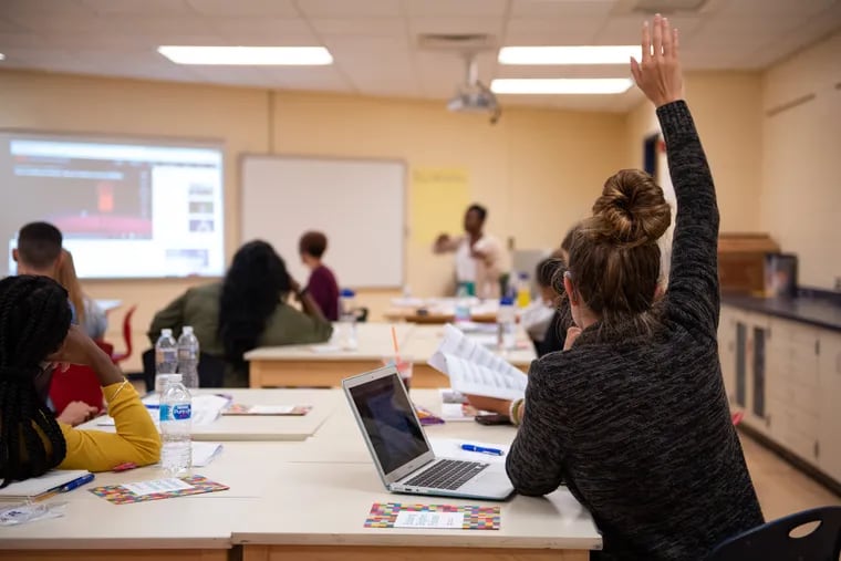 A Philadelphia School District employee raises her hand during a session at new hire orientation, held at the Arts Academy at Benjamin Rush.