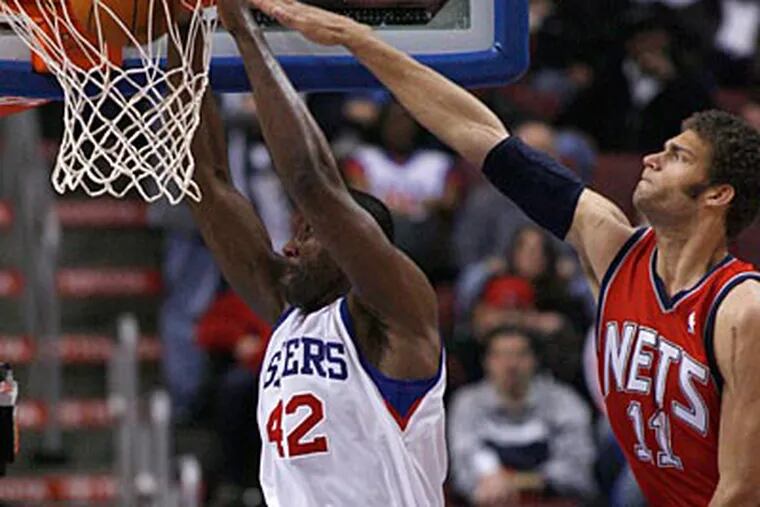Nets center Brook Lopez is unable to block Elton Brand's dunk attempt. (H. Rumph Jr/AP Photo)