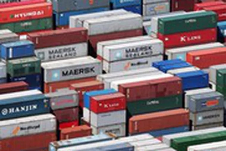 Shipping containers are stacked on a dock in Port Elizabeth, N.J. Reports yesterday said that the U.S. trade gap hit a 16-month high in July and that new applications for jobless benefits were higher than expected.