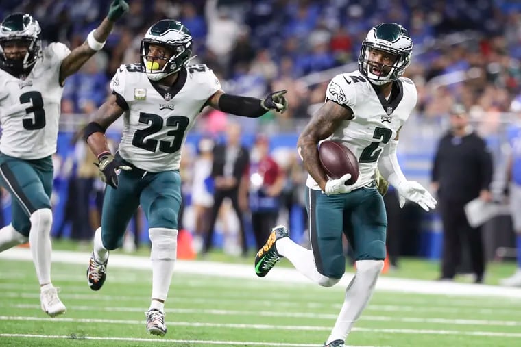 Eagles cornerback Darius Slay runs with the football for a fumble recovery touchdown with teammates cornerback Steven Nelson and safety Rodney McLeod in the third quarter against the Detroit Lions on Sunday, October 31, 2021 in Detroit.