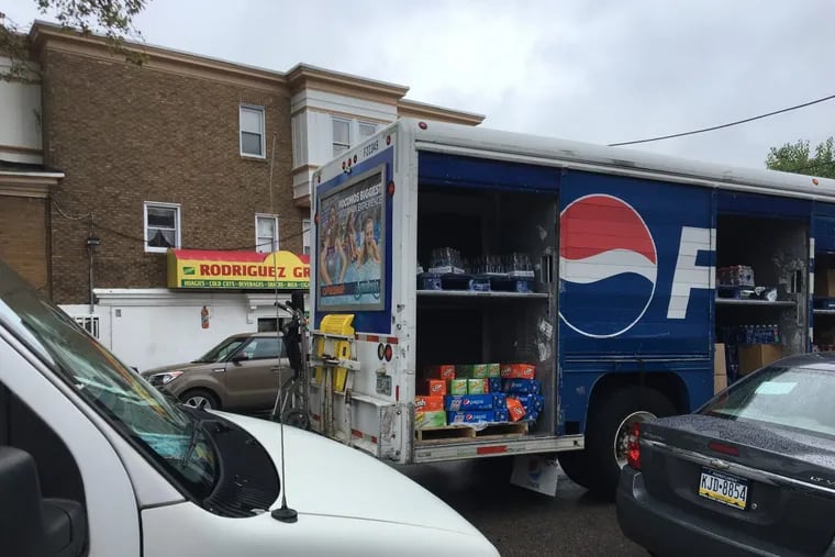 A Pepsi truck delivers soda to Rodriguez Grocery in Overbrook. The store got two deliveries per month before Philadelphia’s tax on sugary drinks went into effect, said cashier Irene Rodriguez. Now, the corner store gets just one delivery per month.