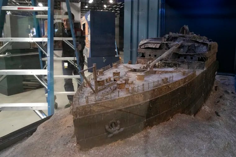 A replica of the Titanic is see while Bruce Tepper, AV manager, works inside the upcoming exhibit “Extreme Deep” at the Academy of Natural Sciences in Philadelphia on Wednesday, March 30, 2022. The exhibit takes a look at life deep in the ocean.