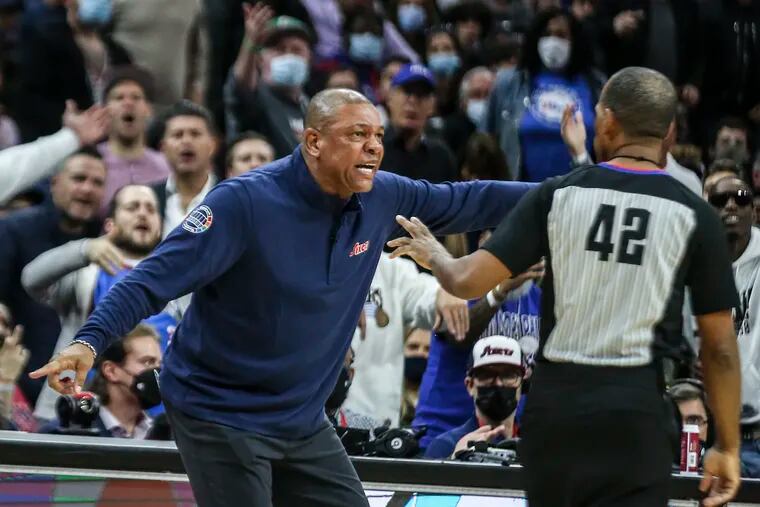 Sixers head coach Doc Rivers appeals to referee Eric Lewis during Tuesday's game against the Bucks.