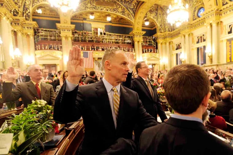 Republican Majority Leader Mike Turzai (center) takes his oath of office during the swearing-in dayat the Pennsylvania General Assembly Hall. Legislators will be on break for the next two weeks.