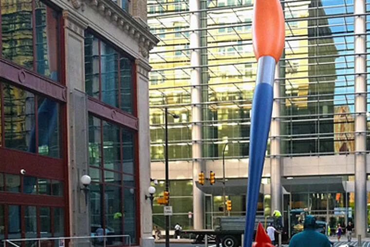 “Paint Torch,” by Claes Oldenburg, beckons pedestrian traffic to Lenfest Plaza, across from the Convention Center on Broad Street. Reactions to the art varied from “beautiful” to “cartoony.” (Jim Selzer / Staff)